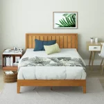 A Zinus Alexis Deluxe Wood Platform Bed Frame with a headboard and footboard