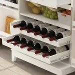A white pantry cabinet with two full-length doors and simple black handles.