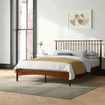 Stylish single bed with a plush pillow and cozy blanket.