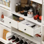 The cabinet has two tall doors with vertical paneling and sleek black handles.