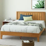 The warm brown tones of a Zinus Alexis Deluxe Wood Platform Bed Frame.